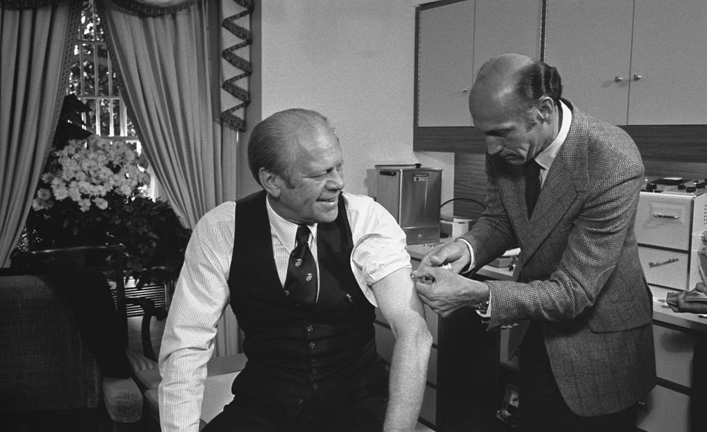 President Gerald Ford receives a swine flu inoculation from his White House physician, William Lukash, in 1976. (David Hume Kennerly/Courtesy Gerald R. Ford Library).